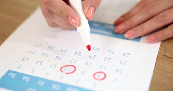 Hand doorkruist dagen in papieren kalender met rode stift. Belangrijke datum in kalenderdag maand en tekendag in kalender - Video