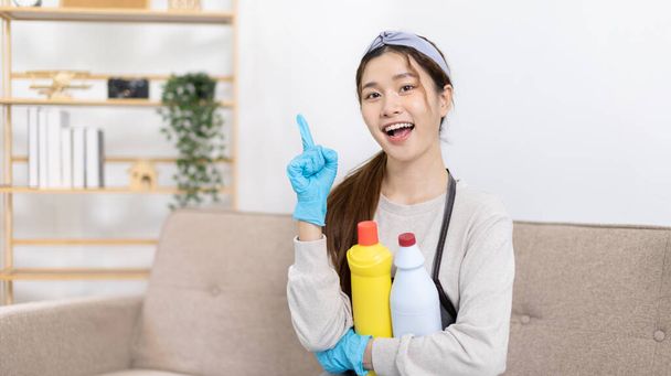 Beautiful Asian housewife wearing apron and cleaning gloves prepares to clean her house, Housework, Daily routine, Big cleaning, Clean and remove germs and dirt in the house, Clean up on weekends. - Foto, Imagem