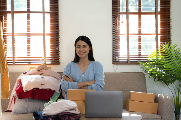 Startup small business entrepreneur SME, asian woman packing box. Portrait of young Asian small business owner in home office, online sell marketing delivery - Photo, Image