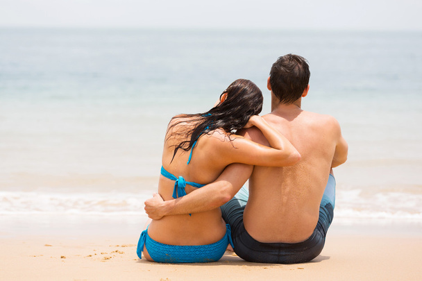 Couple sitting on beach - Фото, зображення