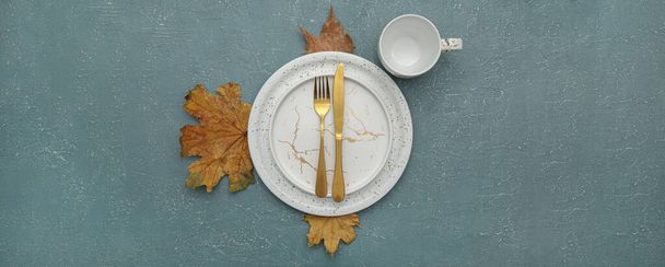 Beautiful autumn table setting with fallen leaves on grunge background, top view - Photo, Image