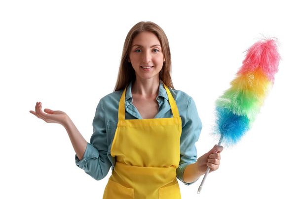 Young woman in yellow apron with duster on white background - Photo, Image