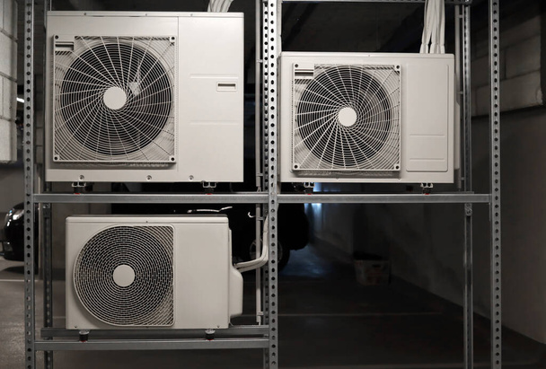 Shelving unit with air conditioners in underground parking lot - Photo, Image