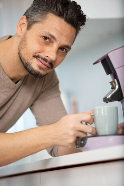 a young male barista making coffee - Zdjęcie, obraz