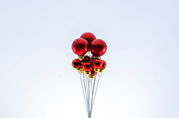 Christmas red baubles ornament set as ballon on top with white background. Minimal holiday concept. - 写真・画像