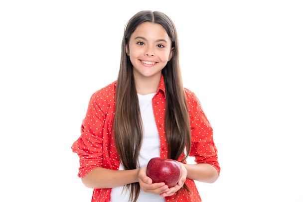 Portrait of confident teen girl with apple going to have healthy snack. Health, nutrition, dieting and kids vitamins. Portrait of happy smiling teenage child girl isolated on white - Photo, Image
