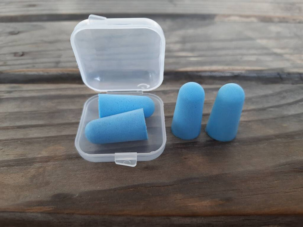 Blue, orange and green earplugs are usually used to protect the ears from working or sleeping - Photo, Image