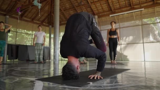 Instructor de yoga muestra cómo hacer posar Sirsasana. Cabecera pose demostración - disparo de cerca - 4K Horizontal video - Metraje, vídeo