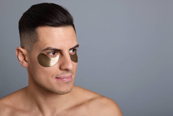 Man with dark under eye patches on grey background. Space for text - Fotó, kép