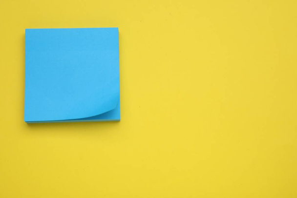 Paper note on yellow background, top view. Space for text - Foto, afbeelding