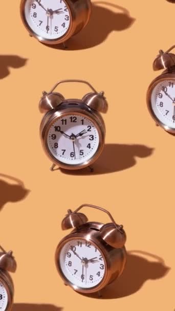 A moving pattern of an alarm clock on an grey background. Creative time concept. Vertical video - Footage, Video
