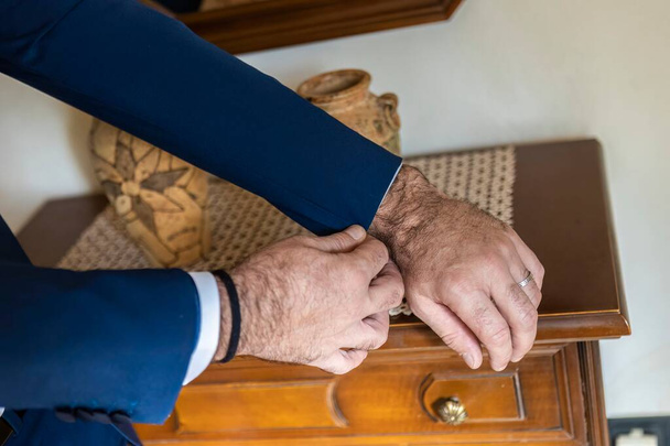 Middle-aged groom prepares for the ceremony wearing the suit - Photo, Image