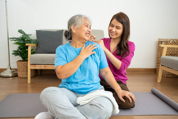 Asian careful caregiver or nurse taking care of the patient in a home.  Concept of happy retirement with care from a caregiver and Savings and senior health insurance, a Happy Family - Φωτογραφία, εικόνα