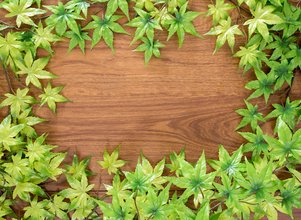Maple leaf with wooden background - Foto, Imagen