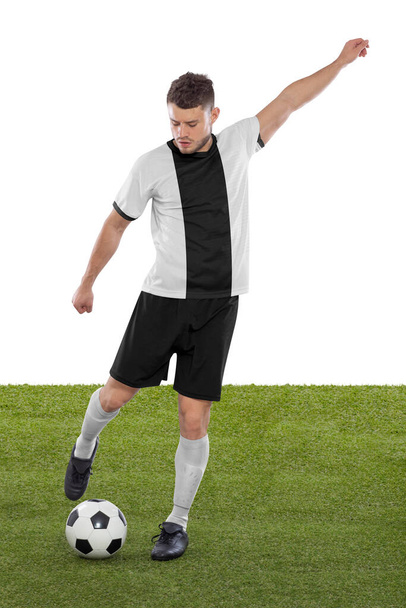 Professional soccer player with white and black Germany national team jersey about to score a goal with an expression of challenge and decision on his face on white background. - Foto, Imagem