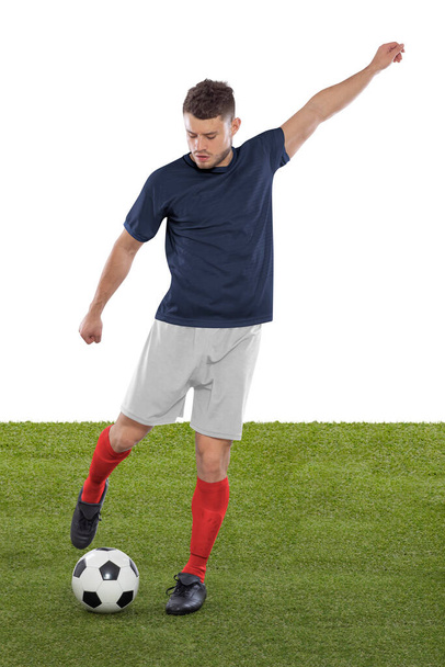 Professional soccer player with blue France national team jersey about to score a goal with an expression of challenge and decision on his face on white background. - Photo, image