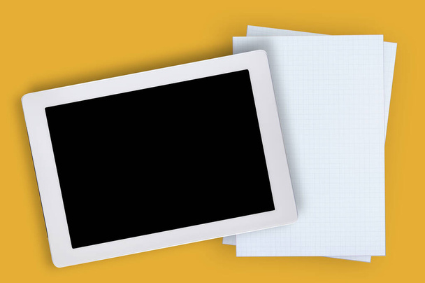 Blank or empty computer digital tablet and white grid paper on yellow background. Digital technology and traditional concept and education idea - Photo, image