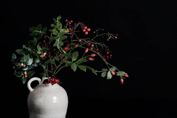 Branches of red berries in white vase. High quality photo - Foto, immagini