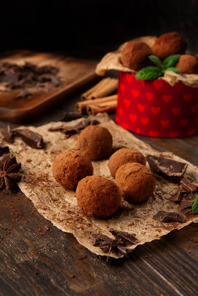 Homemade vegan chocolate truffles, round chocolate candies,  with cocoa powder. Dark Chocolate and Coconut Butter on rustic wooden background. Handmade, Gluten free, Healthy dessert concept. - Foto, Imagem