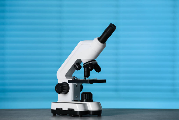 Modern medical microscope on grey table indoors - Photo, Image
