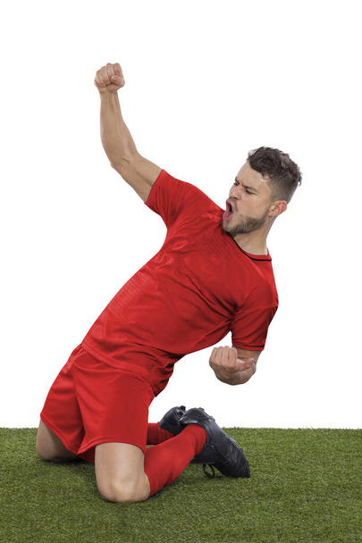 Professional soccer player with a red Denmark national team jersey shouting with excitement for scoring a goal with an expression of challenge and happiness on a white background. - Foto, immagini