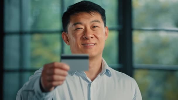 Hombre asiático coreano Empleado japonés hombre de negocios inversionista cliente de servicio bancario tienen tarjeta de crédito de plástico con depósito ilimitado para compras de pedidos por Internet compras comerciales en línea - Metraje, vídeo