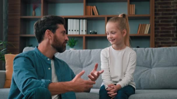 Caucasian man parent father psychologist talk to little cute kid girl teach small child of youth generation. Friendly dialogue with daughter at home parental support parenthood and fatherhood concept - Footage, Video