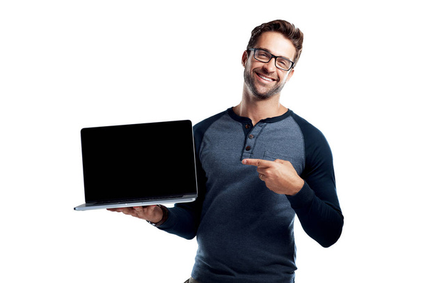 Do yourself a favor and check out my blog. Studio portrait of a handsome young man holding a laptop with a blank screen against a white background - 写真・画像