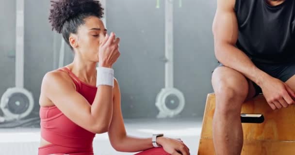 Exercise woman, asthma inhaler breathe at gym with fitness coach for chest relief and wellness. Black woman anxiety, asma attack sitting on floor at training workout for body health in Los Angeles. - Filmati, video