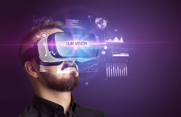 Businessman looking through Virtual Reality glasses with OUR VISION inscription, new business concept - Foto, Imagem