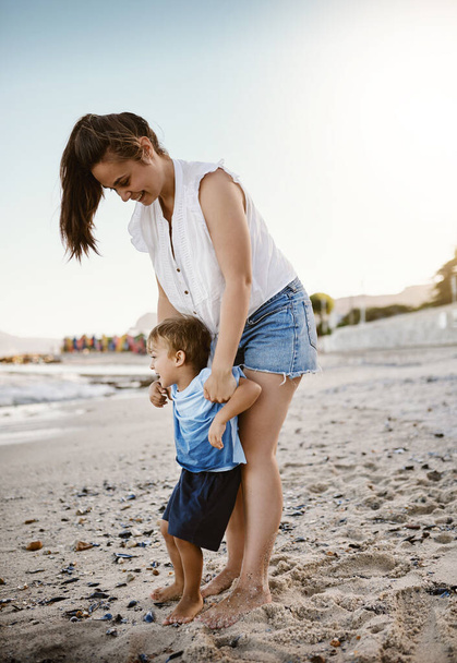 What fun it is under the sun. a mother bonding with her little son at the beach - Photo, Image