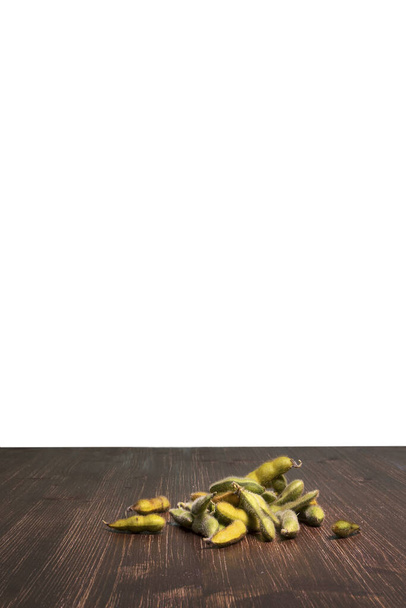 some berries of the soybean plant on a wooden table and a transparent background - Foto, imagen