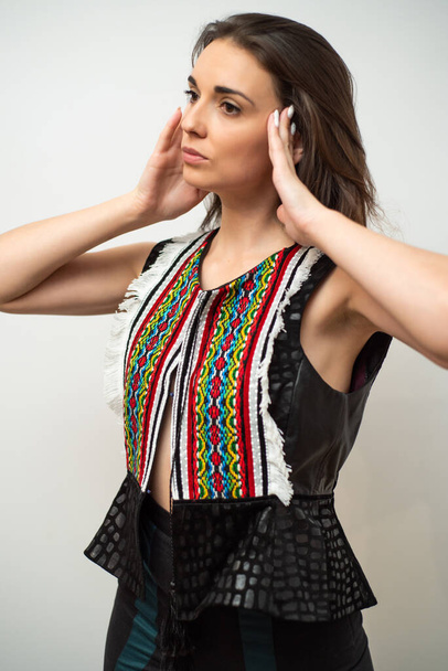 portrait of a beautiful young woman with braids wearing fashion clothing. studio shot on white background. - Photo, Image