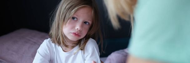 Upset sad little girl communicates with mom at home. Tactile contact of children and parents concept - Photo, image