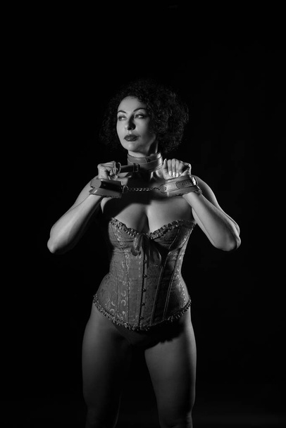 Slave woman in handcuffs on a black background - Zdjęcie, obraz