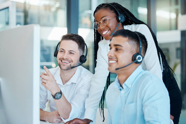 Customer service, call center or telemarketing team and manager or mentor looking happy reading online feedback or sale on website. Diversity in CRM, support and sales consultant training office. - Фото, зображення