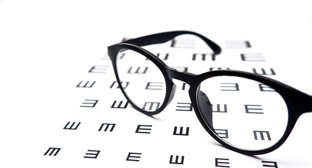 Beyaz arkaplanda siyah gözlük test tablosu. - Fotoğraf, Görsel