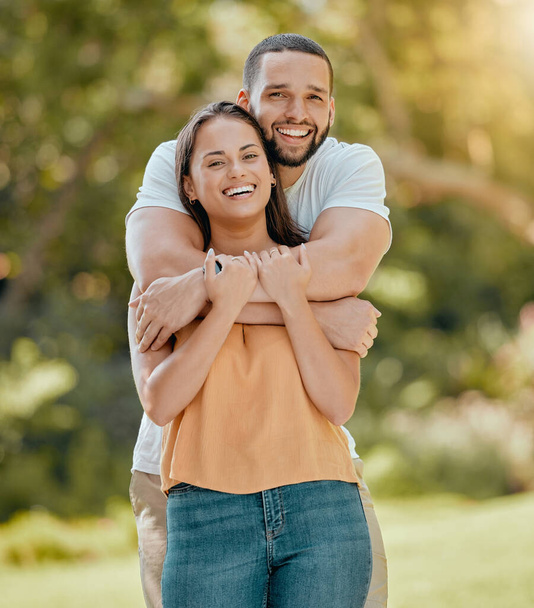 Young couple hugging in park, garden and nature for love, care and romantic date together outdoors in Colombia. Portrait of smile, laughing and relax couple in happy marriage and joyful relationship. - Photo, image