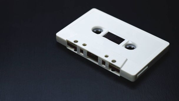 Old audio cassettes on dark wooden background. - Photo, Image