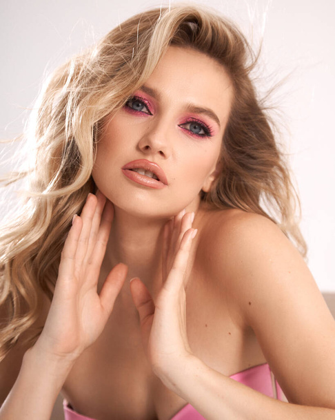 Spring, summer trendy light. Close up beauty portrait of young beautiful woman girl with bright pink, fuchsia color eyeshadow makeup, flawless clean skin.  - Photo, Image