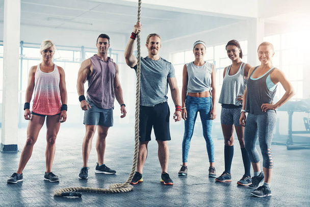 We go through the pain and then reap the benefits. Portrait of a fitness group standing together - Fotoğraf, Görsel