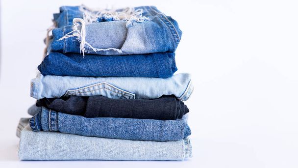 jeans on the background, blue and black jeans lie on a white background, - Фото, изображение