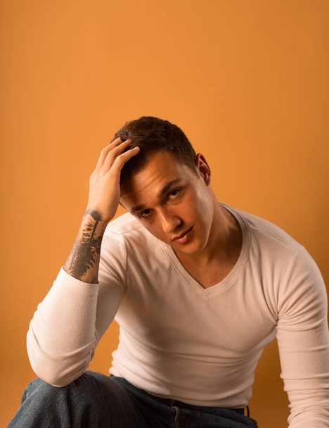 Young man wearing white blouse isolated in studio - Photo, image