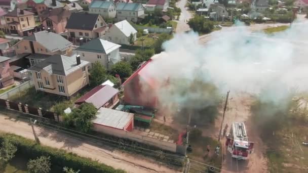 Aerial video footage from a drone. Flight over residential area. Gray smoke is coming out of the cottage. Fire. Road. High quality 4k footage - Footage, Video