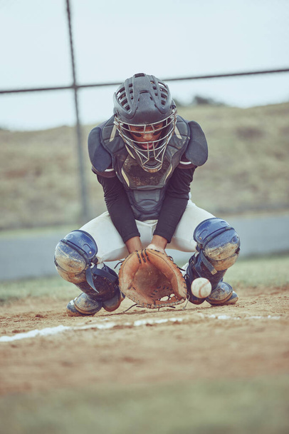Baseball, sports and ball with a catcher on a grass pitch or field during a game or match outdoor. Fitness, exercise and catch with a male baseball player playing a competitive sport outside. - Fotografie, Obrázek