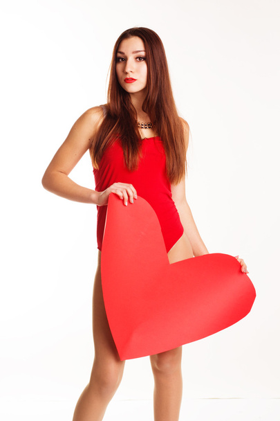 Beautiful teenager girl in red sexy bodi holding paper heart - Photo, Image