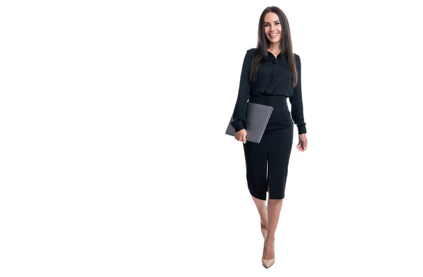 Happy smiling professional business woman businesswoman ceo boss manager going to work holding laptop in business formalwear studio isolated on white, copy space. - Foto, imagen