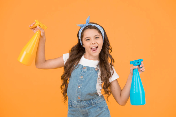 Neat is my middle name. Funny small housekeeper. Little housekeeper hold spray bottles on yellow background. Housekeeper or domestic worker. Household maid. Home cleaner. Cute housekeeper. - Zdjęcie, obraz