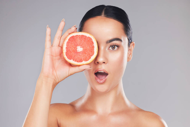Woman, natural beauty and grapefruit skincare treatment for organic treatment for natural, healthy and clean hygiene product. Surprise, wow and happy face of cosmetics model in studio background. - Foto, Imagem