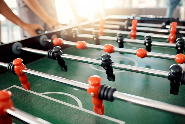 People hands, foosball table and competition in arcade with retro games, soccer action board and plastic toys for team play. Closeup of tabletop soccer challenge, football fun and party entertainment. - Фото, зображення